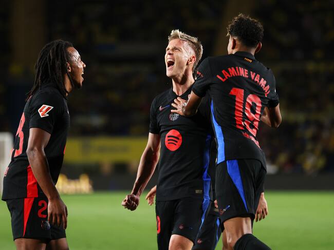 LAS PALMAS, SPAIN - FEBRUARY 22: Dani Olmo of FC Barcelona celebrates with his team mates Jules Kounde and Lamine Yamal after scoring his team's first goal during the LaLiga match between UD Las Palmas and FC Barcelona at Estadio Gran Canaria on February 22, 2025 in Las Palmas, Spain. (Photo by Florencia Tan Jun/Getty Images)