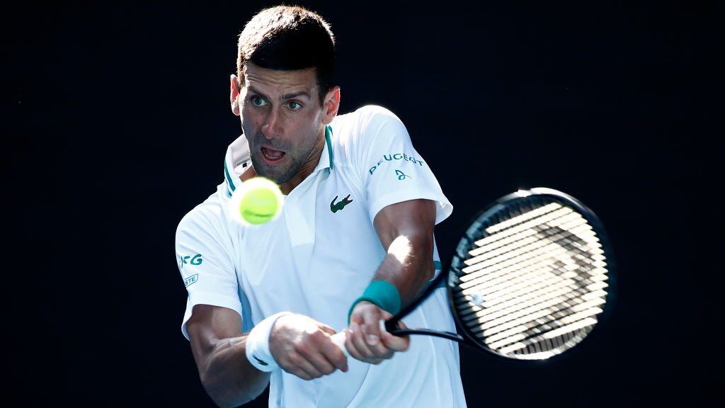 MELBOURNE, AUSTRALIA - FEBRUARY 10: Novak Djokovic of Serbia plays a backhand in his Men's Singles second round match against Frances Tiafoe of the United States during day three of the 2021 Australian Open at Melbourne Park on February 10, 2021 in Melbourne, Australia. (Photo by Daniel Pockett/Getty Images)