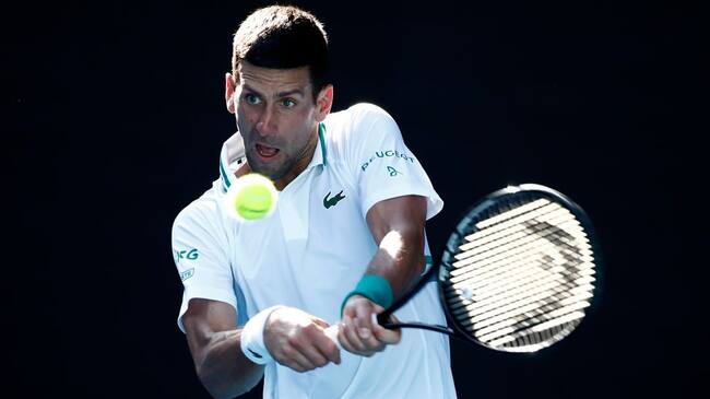 MELBOURNE, AUSTRALIA - FEBRUARY 10: Novak Djokovic of Serbia plays a backhand in his Men's Singles second round match against Frances Tiafoe of the United States during day three of the 2021 Australian Open at Melbourne Park on February 10, 2021 in Melbourne, Australia. (Photo by Daniel Pockett/Getty Images)
