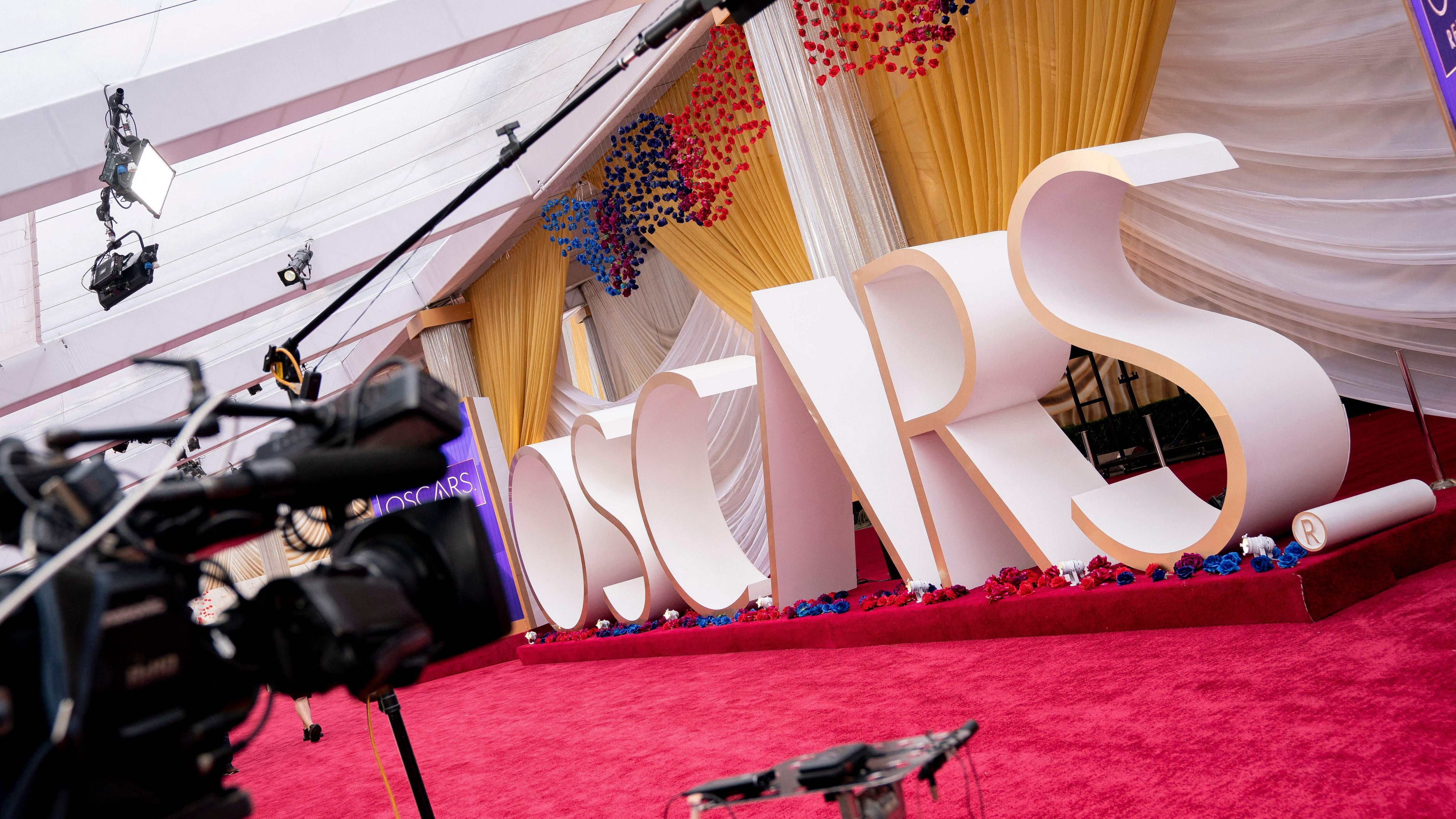 A television camera sits in front of an Oscars sign on the red carpet near the Dolby Theater in Los Angeles, California, on March 27, 2022, ahead of the 94th Academy Awards. (Photo by Stefani Reynolds / AFP) (Photo by STEFANI REYNOLDS/AFP via Getty Images)