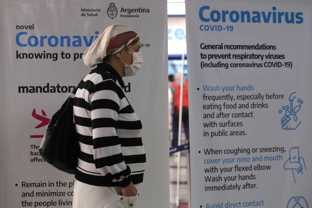 Traveler wearing protective mask arrives at Ezeiza International Airport terminal on March 16, 2020 in Buenos Aires, Argentina. The president, Alberto Fernandez, decided to close the borders for 15 days, to control possible new cases, since in the last days the number of infected increased exponentially. The last flights from Europe arrive in Ezeiza and the controls are exauthentic. (Photo by Carol Smiljan/NurPhoto via Getty Images)