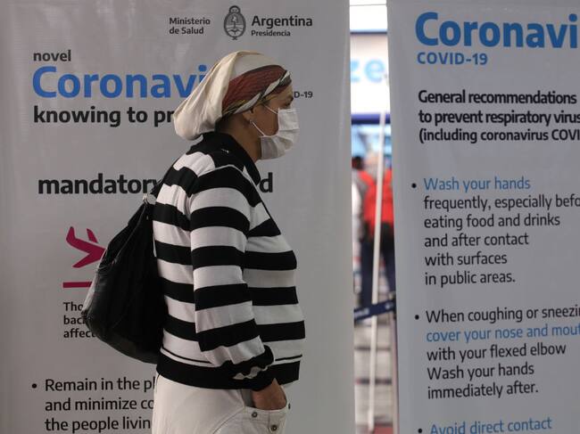 Traveler wearing protective mask arrives at Ezeiza International Airport terminal on March 16, 2020 in Buenos Aires, Argentina. The president, Alberto Fernandez, decided to close the borders for 15 days, to control possible new cases, since in the last days the number of infected increased exponentially. The last flights from Europe arrive in Ezeiza and the controls are exauthentic. (Photo by Carol Smiljan/NurPhoto via Getty Images)