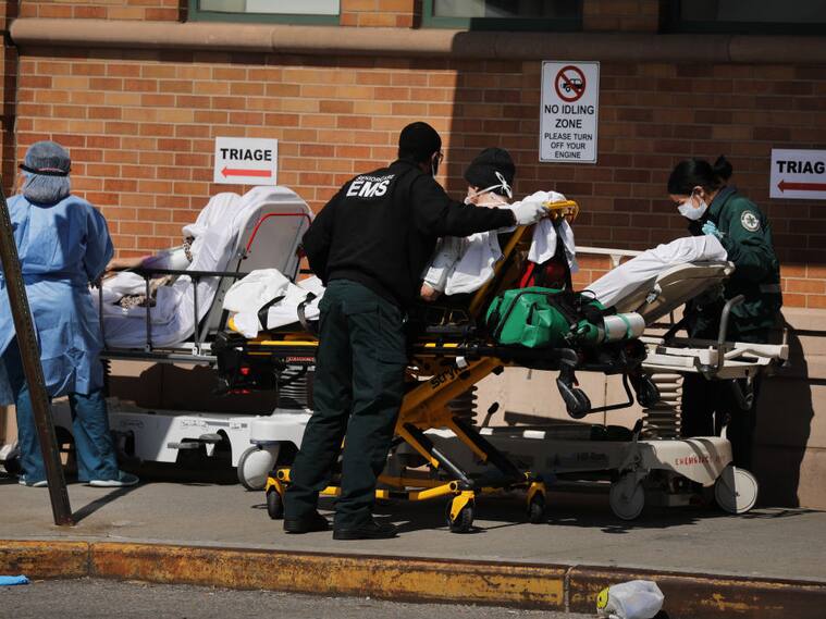 Trabajadores de la salud atienden pacientes a las afueras de un hospital de Nueva York