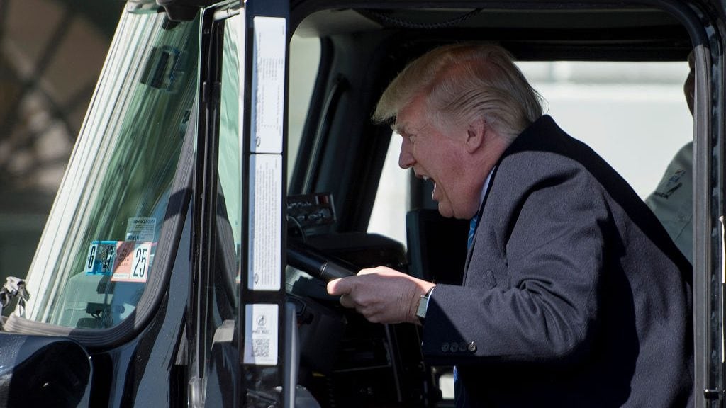 TOPSHOT - US President Donald Trump sits in the drivers seat of a semi-truck as he welcomes truckers and CEOs to the White House in Washington, DC, March 23, 2017, to discuss healthcare. / AFP PHOTO / JIM WATSON (Photo credit should read JIM WATSON/AFP via Getty Images)