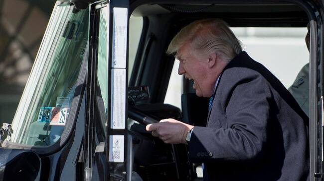 TOPSHOT - US President Donald Trump sits in the drivers seat of a semi-truck as he welcomes truckers and CEOs to the White House in Washington, DC, March 23, 2017, to discuss healthcare. / AFP PHOTO / JIM WATSON (Photo credit should read JIM WATSON/AFP via Getty Images)