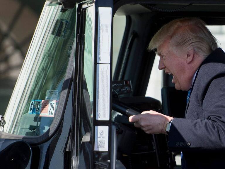 TOPSHOT - US President Donald Trump sits in the drivers seat of a semi-truck as he welcomes truckers and CEOs to the White House in Washington, DC, March 23, 2017, to discuss healthcare. / AFP PHOTO / JIM WATSON        (Photo credit should read JIM WATSON/AFP via Getty Images)