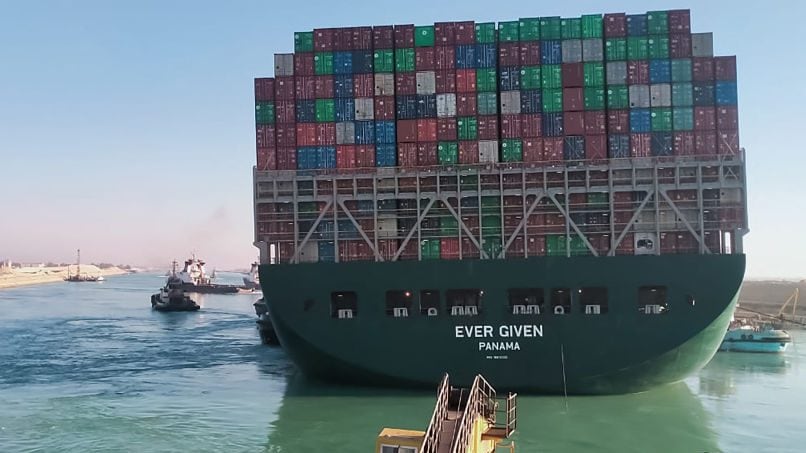This picture taken on March 29, 2021 from a nearby tugboat in the Suez Canal shows a view of the Panama-flagged MV 'Ever Given' (operated by Taiwan-based Evergreen Marine) container ship as it begins to move. - Egypt's Suez Canal Authority said on March 29 the Ever Given container ship, which has been blocking the crucial waterway for nearly a week, has been "reorientated 80 percent in the right direction". Once it is refloated, it will take three and a half days to clear a traffic jam of hundreds of vessels, authorities said. Over 300 ships are currently waiting to travel through the canal. (Photo by - / AFP) (Photo by -/AFP via Getty Images)