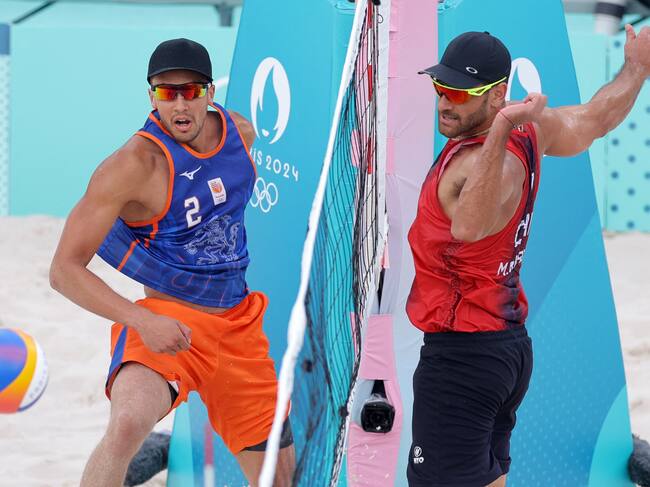 Netherlands' #02 Matthew Immers and Chile's #01 Marco Grimalt watch the ball in the men's pool B beach volleyball match between Netherlands and Chile during the Paris 2024 Olympic Games at the Eiffel Tower Stadium in Paris on July 31, 2024. (Photo by Thomas SAMSON / AFP) (Photo by THOMAS SAMSON/AFP via Getty Images)