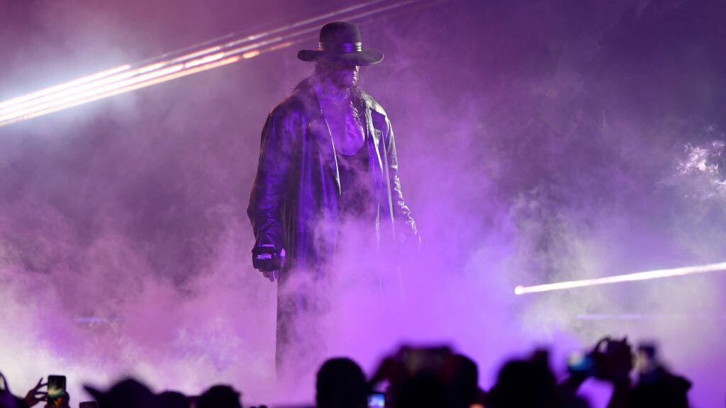 TOPSHOT - World Wrestling Entertainment star The Undertaker makes his way to the ring during a match at the World Wrestling Entertainment (WWE) Super Showdown event in the Saudi Red Sea port city of Jeddah late on January 7, 2019. (Photo by Amer HILABI / AFP)        (Photo credit should read AMER HILABI/AFP via Getty Images)