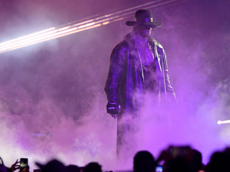 TOPSHOT - World Wrestling Entertainment star The Undertaker makes his way to the ring during a match at the World Wrestling Entertainment (WWE) Super Showdown event in the Saudi Red Sea port city of Jeddah late on January 7, 2019. (Photo by Amer HILABI / AFP)        (Photo credit should read AMER HILABI/AFP via Getty Images)