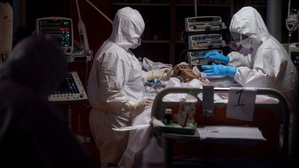 ROME, ITALY - MARCH 26: (EDITORS NOTE: Parts of this image have been obscured for privacy reasons) Doctors treat COVID-19 patients in an intensive care unit at the third Covid 3 Hospital (Istituto clinico CasalPalocco) during the Coronavirus emergency on March 26, 2020, in Rome, Italy. Hospitals in Italy are under increased pressure as they battle to treat those who have contracted COVID-19. The Italian government continues to enforce the nationwide lockdown measures to control the spread of COVID-19. (Photo by Antonio Masiello/Getty Images)