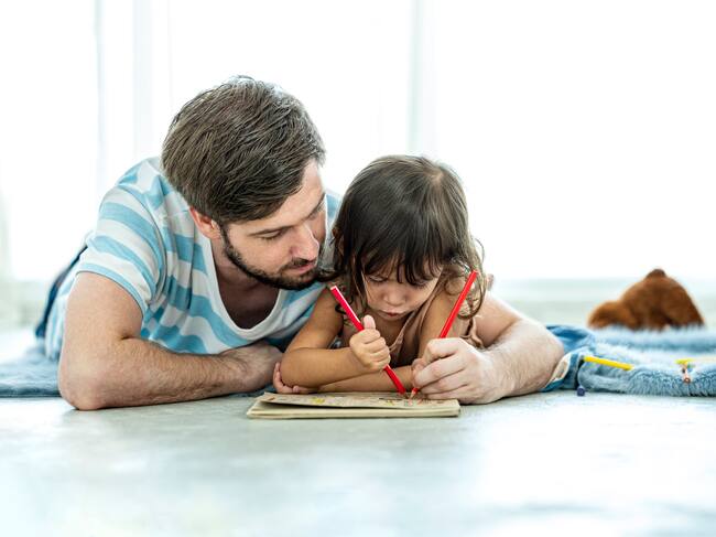 Unemployed stress father while teaching his daughter to drawing at home to relax of impact from corona-virus, lock-down from government.