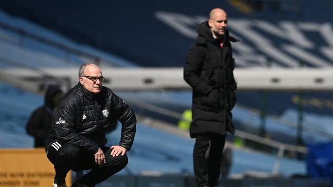 Manchester City's Spanish manager Pep Guardiola (R) and Leeds United's Argentinian head coach Marcelo Bielsa (L) watch the game during the English Premier League football match between Manchester City and Leeds United at the Etihad Stadium in Manchester, north west England, on April 10, 2021. - RESTRICTED TO EDITORIAL USE. No use with unauthorized audio, video, data, fixture lists, club/league logos or 'live' services. Online in-match use limited to 120 images. An additional 40 images may be used in extra time. No video emulation. Social media in-match use limited to 120 images. An additional 40 images may be used in extra time. No use in betting publications, games or single club/league/player publications. (Photo by Michael Regan / POOL / AFP) / RESTRICTED TO EDITORIAL USE. No use with unauthorized audio, video, data, fixture lists, club/league logos or 'live' services. Online in-match use limited to 120 images. An additional 40 images may be used in extra time. No video emulation. Social media in-match use limited to 120 images. An additional 40 images may be used in extra time. No use in betting publications, games or single club/league/player publications. / RESTRICTED TO EDITORIAL USE. No use with unauthorized audio, video, data, fixture lists, club/league logos or 'live' services. Online in-match use limited to 120 images. An additional 40 images may be used in extra time. No video emulation. Social media in-match use limited to 120 images. An additional 40 images may be used in extra time. No use in betting publications, games or single club/league/player publications. (Photo by MICHAEL REGAN/POOL/AFP via Getty Images)