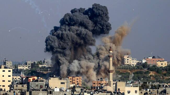 TOPSHOT - Smoke billows from Israeli air strikes in Gaza City, controlled by the Palestinian Hamas movement, on May 11, 2021. - Israel and the Islamist movement Hamas in Gaza exchanged heavy fire, killing at least 26 Palestinians and two Israelis, in an escalation sparked by violent unrest at Jerusalem's flashpoint Al-Aqsa Mosque compound. (Photo by ANAS BABA / AFP) (Photo by ANAS BABA/AFP via Getty Images)