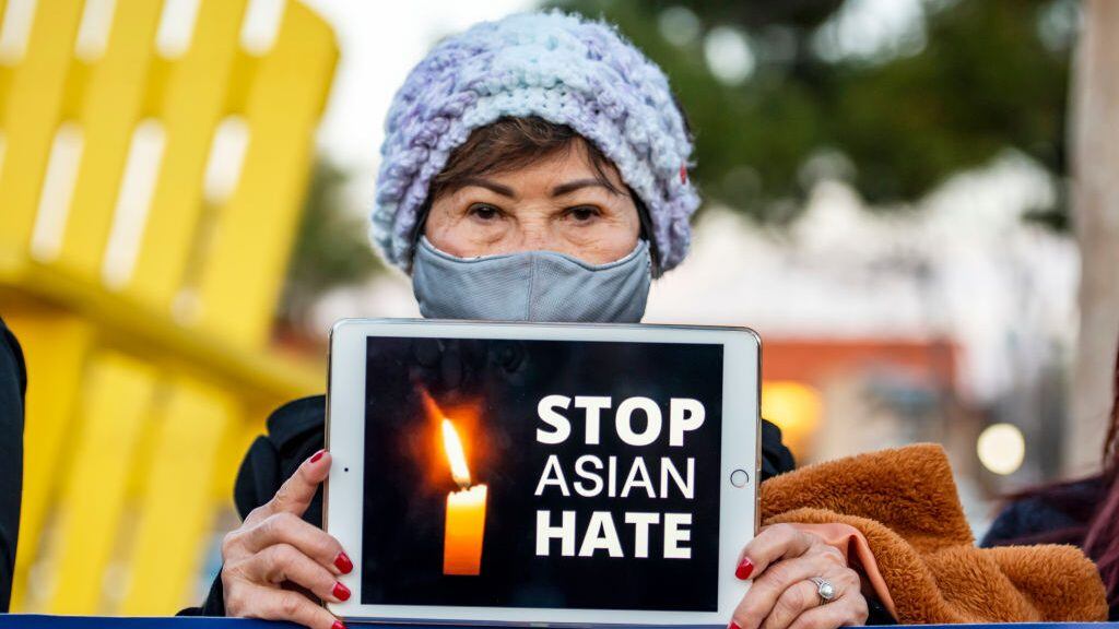 GARDEN GROVE, CA - MARCH 17: Kien Nguyen, 76 of Fountain Valley holds up an iPad with the message "Stop Asian Hate" during a vigil sponsored by the Asian American community at Community Center Park in Garden Grove on Wednesday, March 17, 2021 in honor of victims of the Atlanta-area spa shootings. (Photo by Leonard Ortiz/MediaNews Group/Orange County Register via Getty Images)