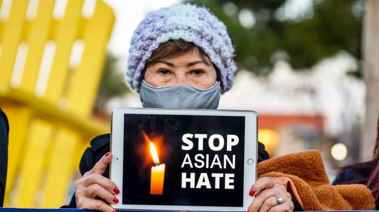 GARDEN GROVE, CA - MARCH 17: Kien Nguyen, 76 of Fountain Valley holds up an iPad with the message "Stop Asian Hate" during a vigil sponsored by the Asian American community at Community Center Park in Garden Grove on Wednesday, March 17, 2021 in honor of victims of the Atlanta-area spa shootings. (Photo by Leonard Ortiz/MediaNews Group/Orange County Register via Getty Images)