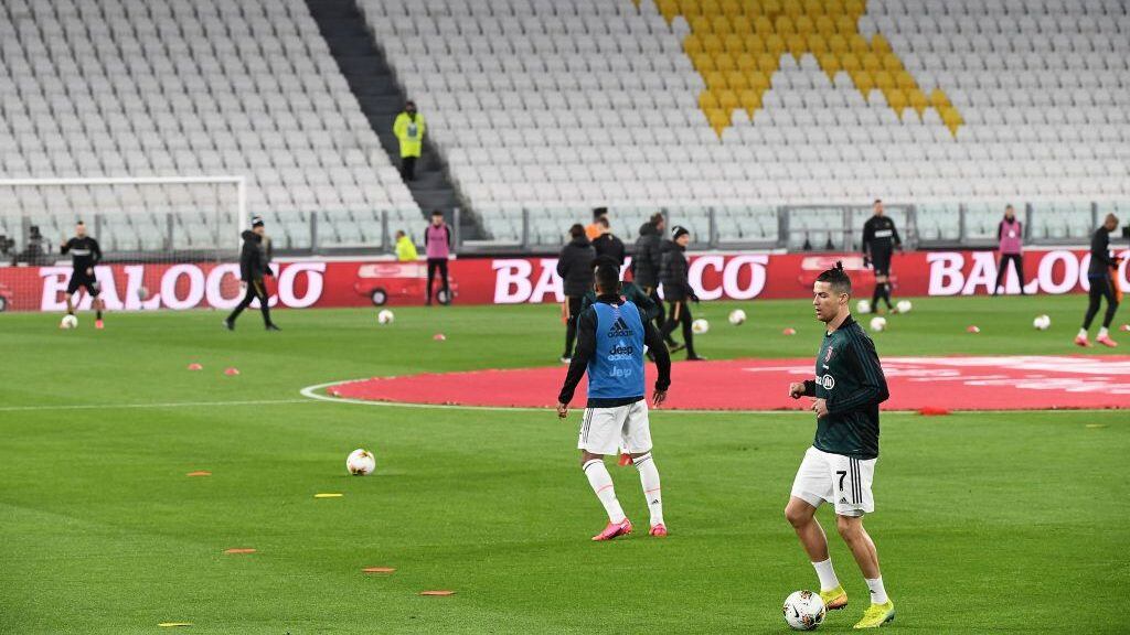 Juventus' Portuguese forward Cristiano Ronaldo (front) warms up in the empty stadium as the match will be played behind closed doors due toi the novel coronavirus before the Italian Serie A football match Juventus vs Inter Milan, at the Juventus stadium in Turin on March 8, 2020. (Photo by Vincenzo PINTO / AFP) (Photo by VINCENZO PINTO/AFP via Getty Images)