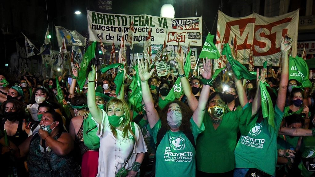 BUENOS AIRES, ARGENTINA - DECEMBER 30: Pro-choice demonstrators celebrate after the right to an abortion is legalized on December 30, 2020 in Buenos Aires, Argentina. The proposal authorizes legal, voluntary and free interruption of pregnancy until the 14th week while allowing doctor's conscientious objection. It is the ninth bill to legalize abortion treated by the Argentine Congress and the first one publicly supported by the president of the country. (Photo by Marcelo Endelli/Getty Images)