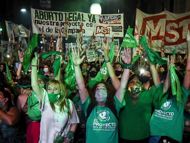 BUENOS AIRES, ARGENTINA - DECEMBER 30:  Pro-choice demonstrators celebrate after the right to an abortion is legalized on December 30, 2020 in Buenos Aires, Argentina. The proposal authorizes legal, voluntary and free interruption of pregnancy until the 14th week while allowing doctor&#039;s conscientious objection. It is the ninth bill to legalize abortion treated by the Argentine Congress and the first one publicly supported by the president of the country. (Photo by Marcelo Endelli/Getty Images)