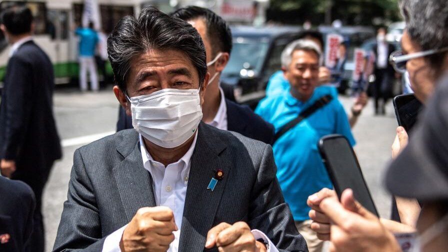 Former Japanese prime minister Shinzo Abe interacts with supporters as he joins the election campaign for Liberal Democratic Party member Kentaro Asahi (not pictured) ahead of the House of Councillors election on July 10, in Tokyo on June 22, 2022. (Photo by Philip FONG / AFP) (Photo by PHILIP FONG/AFP via Getty Images)