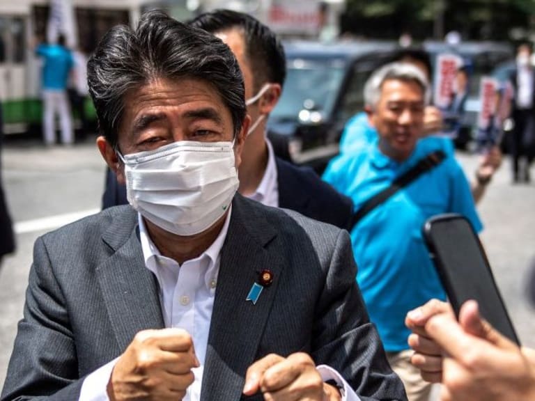 Former Japanese prime minister Shinzo Abe interacts with supporters as he joins the election campaign for Liberal Democratic Party member Kentaro Asahi (not pictured) ahead of the House of Councillors election on July 10, in Tokyo on June 22, 2022. (Photo by Philip FONG / AFP) (Photo by PHILIP FONG/AFP via Getty Images)