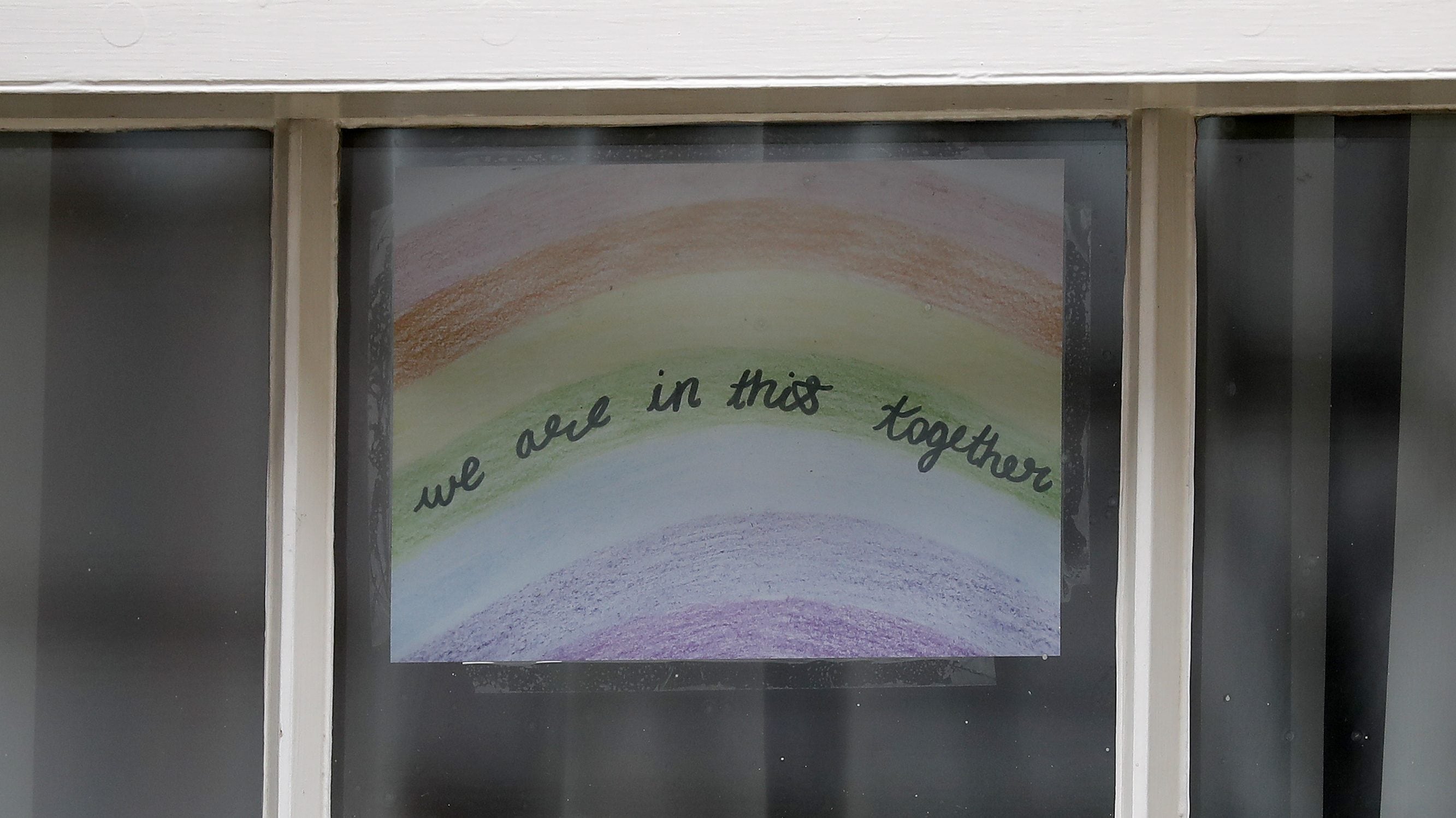 A poster of a rainbow, being used as a symbol of hope during the COVID-19 pandemic, with the words "we are in this together" is pictured in a window at 10 Downing Street, the official residence of Britain's Prime Minister, in central London on April 8, 2020, ahead of the Government's daily COVID-19 news briefing. - Britain's prime minister began a third day in intensive care battling the new coronavirus, which has struck at the heart of the British government, infected more than 55,000 people across the country and killed nearly 6,200. (Photo by Tolga AKMEN / AFP) (Photo by TOLGA AKMEN/AFP via Getty Images)