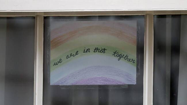 A poster of a rainbow, being used as a symbol of hope during the COVID-19 pandemic, with the words "we are in this together" is pictured in a window at 10 Downing Street, the official residence of Britain's Prime Minister, in central London on April 8, 2020, ahead of the Government's daily COVID-19 news briefing. - Britain's prime minister began a third day in intensive care battling the new coronavirus, which has struck at the heart of the British government, infected more than 55,000 people across the country and killed nearly 6,200. (Photo by Tolga AKMEN / AFP) (Photo by TOLGA AKMEN/AFP via Getty Images)