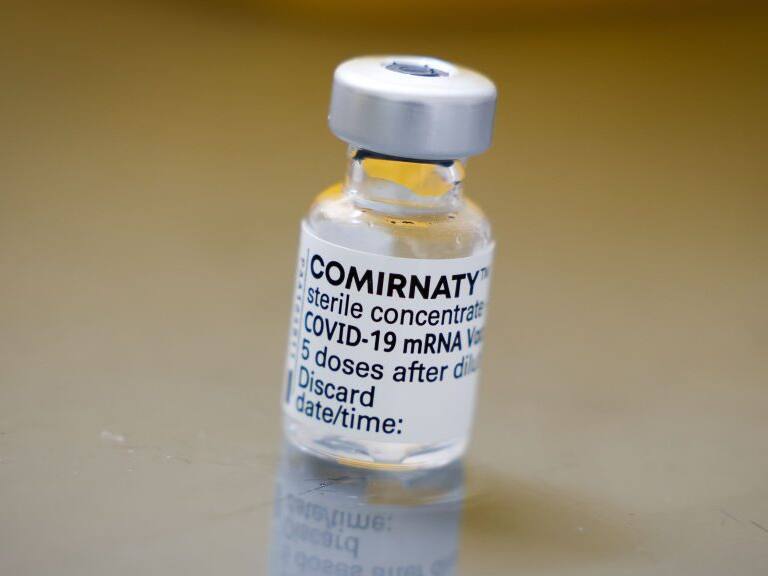 09 March 2021, Schleswig-Holstein, Hooge: An empty vial with the vaccine from Biontech/Pfizer stands on a table in the hospital room on the Hallig. The first Hallig residents were vaccinated against Corona on Hooge on Tuesday. Photo: Christian Charisius/dpa (Photo by Christian Charisius/picture alliance via Getty Images)