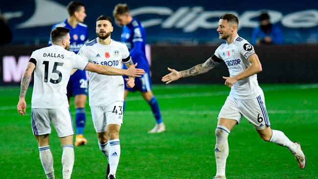 Leeds United's Northern Irish midfielder Stuart Dallas (L) celebrates scoring his team's first goal with Leeds United's English-born Scottish defender Liam Cooper (R) during the English Premier League football match between Leeds United and Leicester City at Elland Road in Leeds, northern England on November 2, 2020. (Photo by PETER POWELL / POOL / AFP) / RESTRICTED TO EDITORIAL USE. No use with unauthorized audio, video, data, fixture lists, club/league logos or 'live' services. Online in-match use limited to 120 images. An additional 40 images may be used in extra time. No video emulation. Social media in-match use limited to 120 images. An additional 40 images may be used in extra time. No use in betting publications, games or single club/league/player publications. / (Photo by PETER POWELL/POOL/AFP via Getty Images)