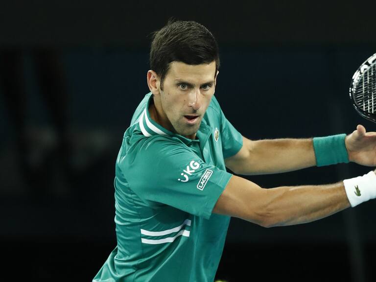 MELBOURNE, AUSTRALIA - FEBRUARY 08: Novak Djokovic of Serbia plays a backhand in his Men's Singles first round match against Jeremy Chardy of France during day one of the 2021 Australian Open at Melbourne Park on February 08, 2021 in Melbourne, Australia. (Photo by Darrian Traynor/Getty Images)