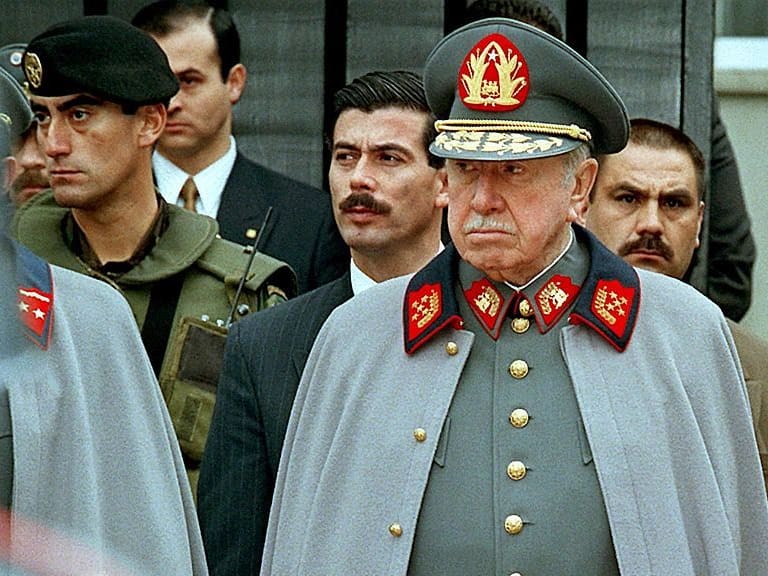 SANTIAGO, CHILE: Former Chilean leader and current Commander of the Chilean Armed Forces, Gen. Augusto Pinochet listens to a military band playing before his residence in Santiago 11 September to commemorate the 24th anniversary of the coup he led to overthrow the government of Salvador Allende. Pinochet is expected to retire in 1998. AFP PHOTO/CRIS BOURONCLE (Photo credit should read CRIS BOURONCLE/AFP via Getty Images)