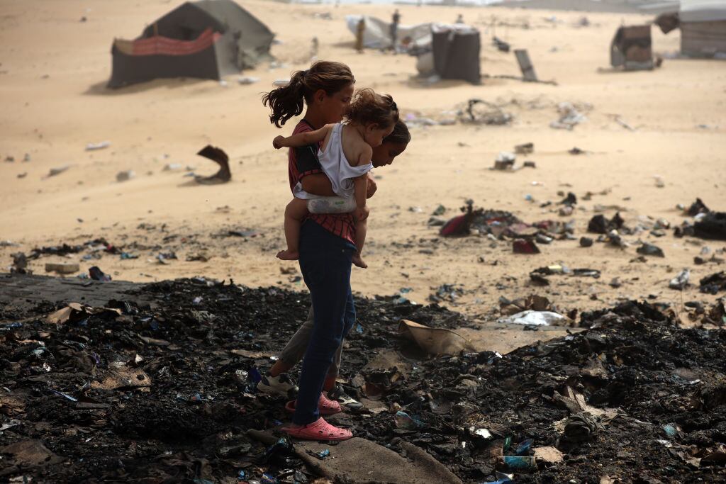 Palestinians are gathering at the site of an Israeli strike on a camp for internally displaced people in Rafah, on May 27, 2024, amid ongoing battles between Israel and the Palestinian Hamas militant group. (Photo by Majdi Fathi/NurPhoto via Getty Images)