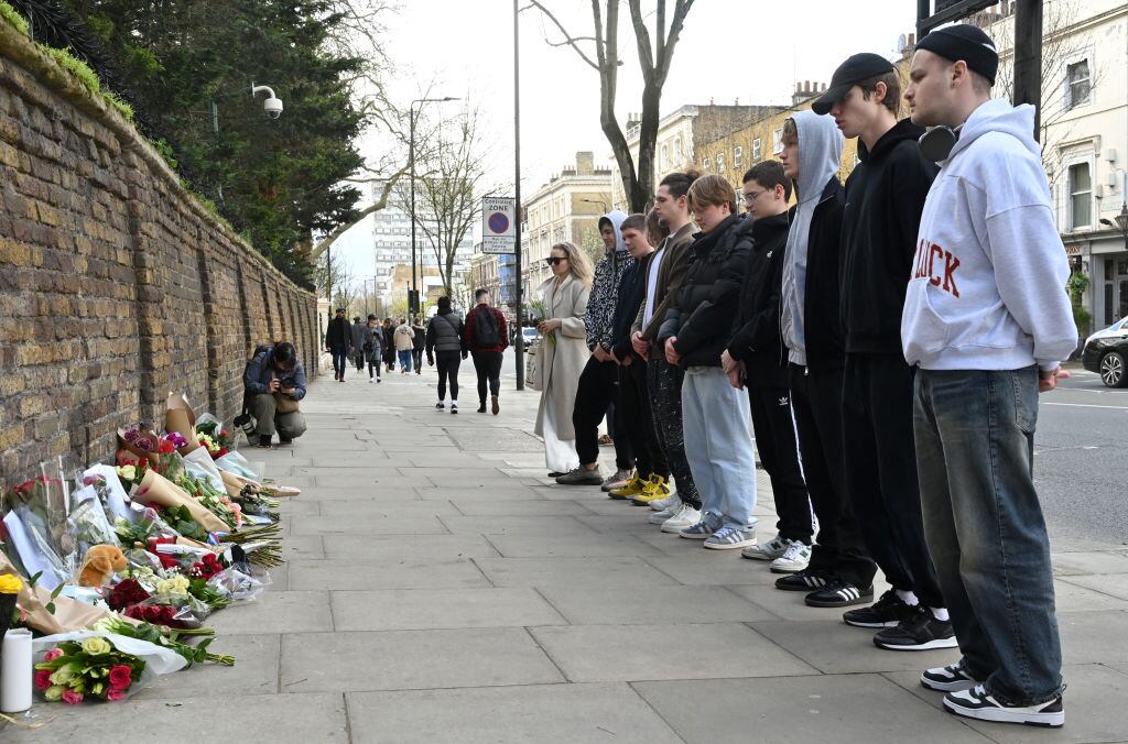 People pay their respects after laying flowers outside the Russian embassy in London on March 23, 2024, a day after a gun attack in Krasnogorsk, outside Moscow. Camouflaged assailants opened fire at the packed Crocus City Hall in Moscow's northern suburb of Krasnogorsk on March 22, 2024, ahead of a concert by Soviet-era rock band Piknik in the deadliest attack in Russia for at least a decade. Russia on March 23, 2024, said it had arrested 11 people - including four gunmen - over the attack on a Moscow concert hall claimed by Islamic State, as the death toll rose to 115 people. (Photo by JUSTIN TALLIS / AFP) (Photo by JUSTIN TALLIS/AFP via Getty Images)