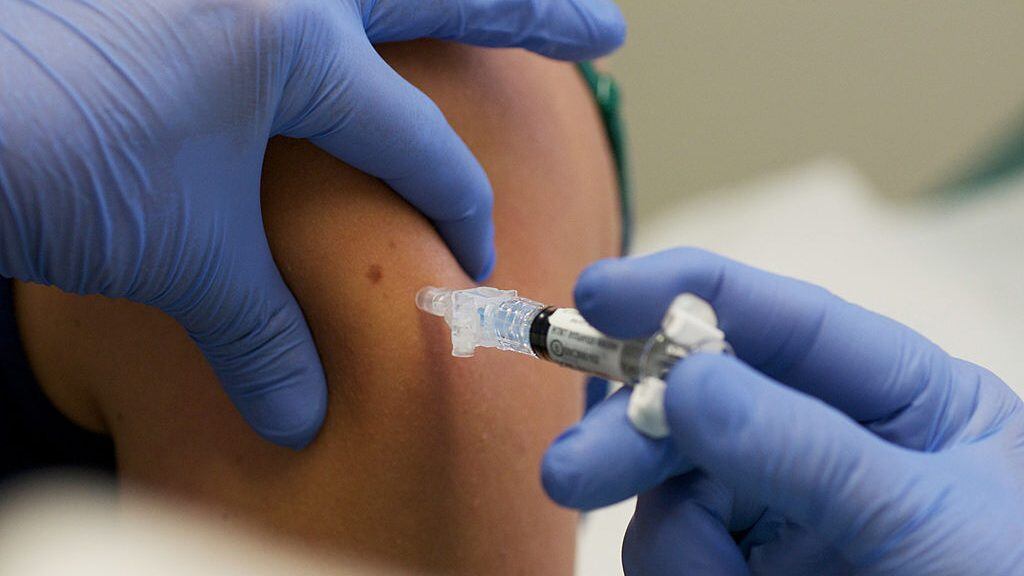IOWA CITY, IA - AUGUST 11: Marisa Grunder, 27 of Wilton, Iowa, is given a shot during trials of an H1N1 vaccine, developed by CSL of Australia, at University of Iowa Health Care, the University's medical center, on August 11, 2009 in Iowa City, Iowa. The university's medical center is one of 8 trial sites across the nation conducting human studies on the new vaccine which is looking at optimal dosage levels for a variety of age groups. (Photo by David Greedy/Getty Images)