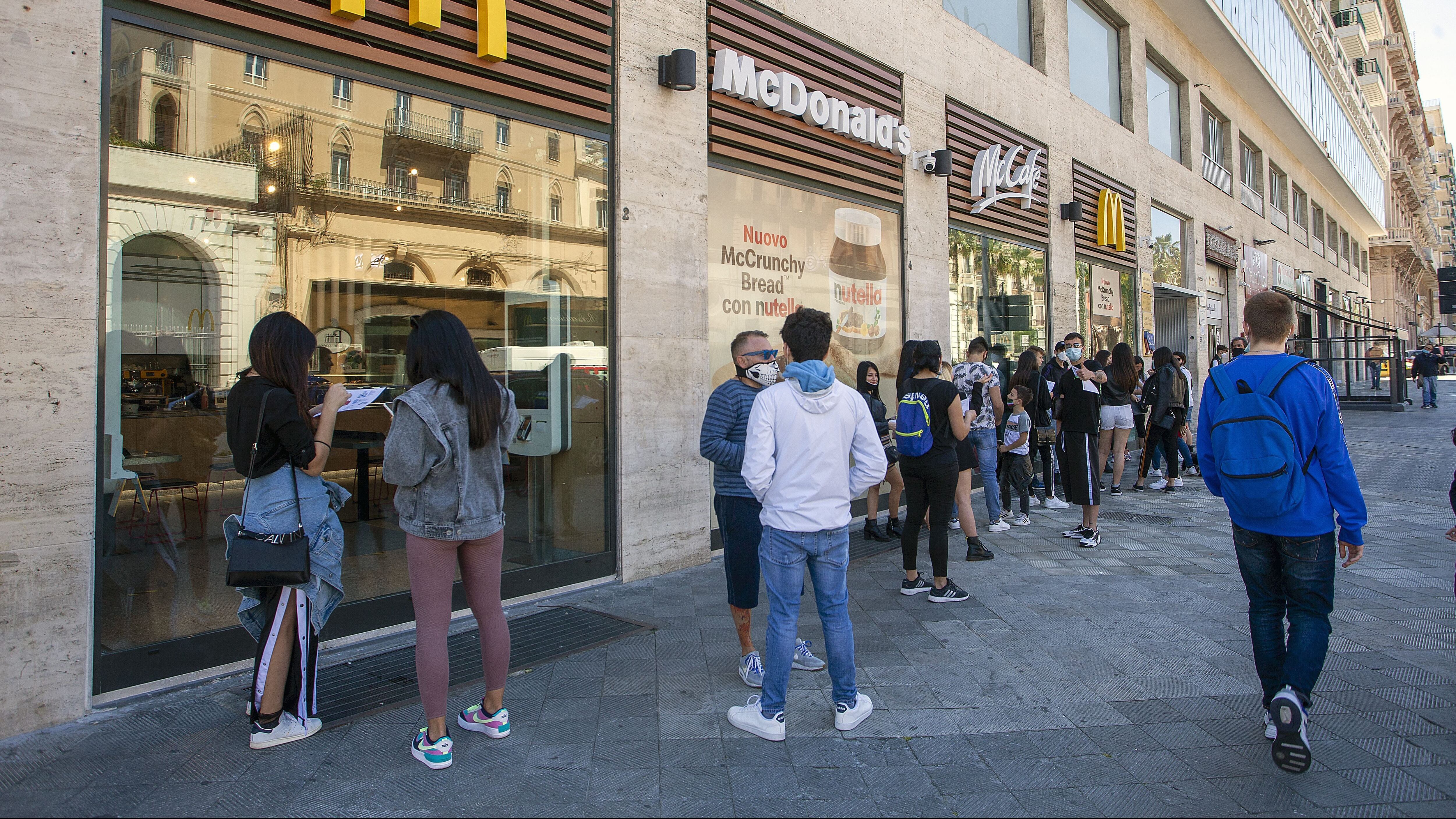 BARI, ITALY - MAY 08: Customers queue outside a McDonald's restaurant which has just reopened on May 08, 2020 in Bari, Italy. Italy was the first country to impose a nationwide lockdown to stem the transmission of the Coronavirus (Covid-19), and its restaurants, theaters and many other businesses remain closed. (Photo by Donato Fasano/Getty Images)