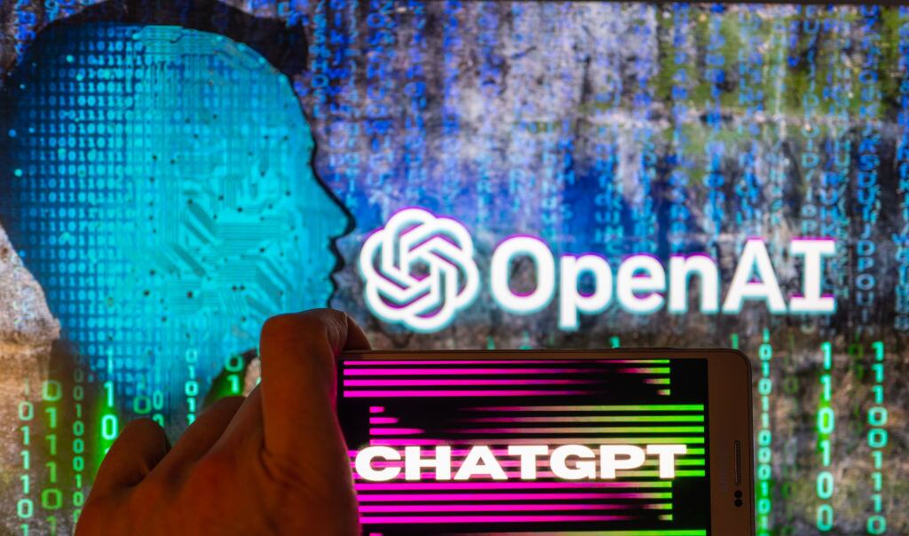 OpenAI logo seen on screen with ChatGPT website displayed on mobile seen in this illustration in Brussels, Belgium, on December 12, 2022.   (Photo by Jonathan Raa/NurPhoto via Getty Images)