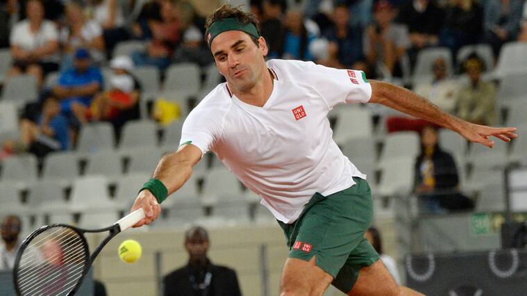 Switzerland's Roger Federer plays a return to Spain's Rafael Nadal during their tennis match at The Match in Africa at the Cape Town Stadium, in Cape Town on February 7, 2020. (Photo by RODGER BOSCH / AFP) (Photo by RODGER BOSCH/AFP via Getty Images)