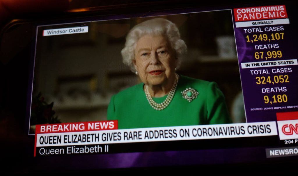 A person in Milan, Italy, on April 5, 2020, looks through his phone at Queen Elizabeth of England's speech. The Queen Elizabeth, for the fourth time in her history, has sent a message to the nation about the tragic emergency of the Covid-19 (Photo by Mairo Cinquetti/NurPhoto via Getty Images)