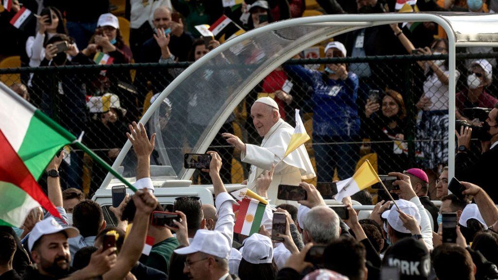 ERBIL, IRAQ - MARCH 07: (EDITORS NOTE: Transmitted with alternate crop) Pope Francis waves to the crowd as he arrives to conduct mass at the  Franso Hariri Stadium on March 07, 2021 in Erbil, Iraq. Pope Francis arrived in Erbil, the final stop of his historic four-day visit, the first-ever papal visit to Iraq. In his first foreign trip since the start of the pandemic, Pope Francis visited Baghdad, Najaf, Erbil, and the cities of Qaraqosh and Mosul, which were heavily destroyed by ISIS. Although the trip is seen as an act of solidarity, the Vatican has been forced to defend the decision to go ahead with the papal visit amid the ongoing coronavirus pandemic, as Iraq is currently seeing a spike in infection rates as it faces a deadly second wave of the virus. (Photo by Chris McGrath/Getty Images)