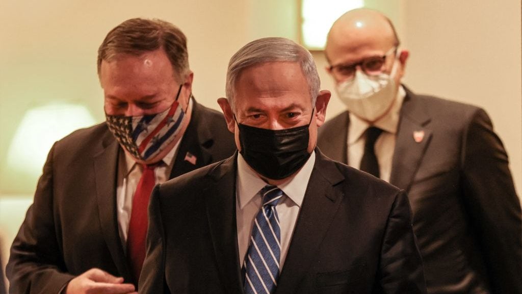 (L to R) US Secretary of State Mike Pompeo, Israeli Prime Minister Benjamin Netanyahu, and Bahrain's Foreign Minister Abdullatif bin Rashid Al Zayani, all mask-clad due to the COVID-19 coronavirus pandemic, arrive for a press conference after their trilateral meeting in Jerusalem on November 18, 2020. (Photo by Menahem KAHANA / POOL / AFP) (Photo by MENAHEM KAHANA/POOL/AFP via Getty Images)
