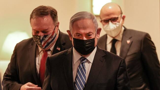 (L to R) US Secretary of State Mike Pompeo, Israeli Prime Minister Benjamin Netanyahu, and Bahrain's Foreign Minister Abdullatif bin Rashid Al Zayani, all mask-clad due to the COVID-19 coronavirus pandemic, arrive for a press conference after their trilateral meeting in Jerusalem on November 18, 2020. (Photo by Menahem KAHANA / POOL / AFP) (Photo by MENAHEM KAHANA/POOL/AFP via Getty Images)
