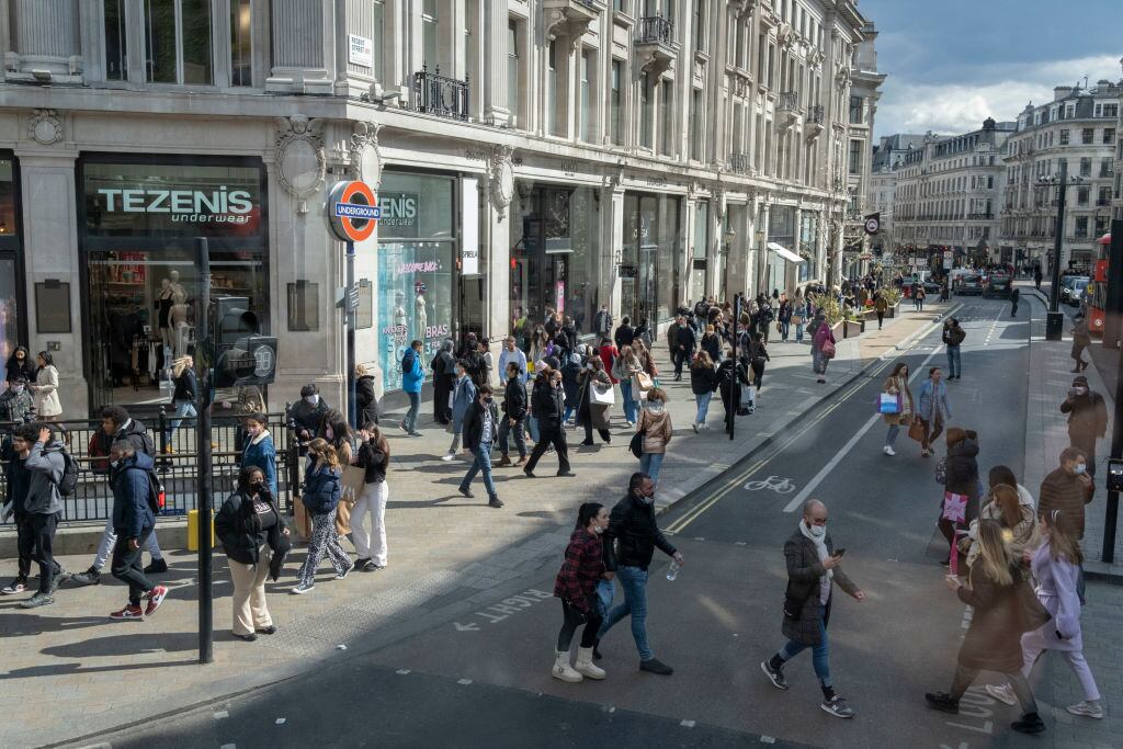 On the day that the UK government eased Covid restrictions to allow non-essential businesses such as shops, pubs, bars, gyms and hairdressers to re-open, crowds of shoppers walk across Oxford Circus, on 12th April 2021, in London, England. (Photo by Richard Baker / In Pictures via Getty Images)