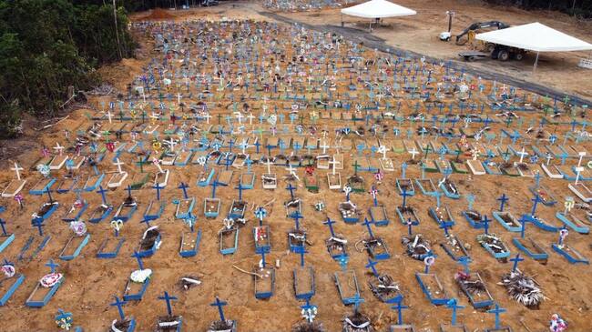 TOPSHOT - Aerial view of an area at the Nossa Senhora Aparecida cemetery where new graves have been dug in Manaus, Brazil, on May 22, 2020 amid the novel Covid-19 coronavirus pandemic. - Brazil, the hardest-hit Latin American country in the coronavirus pandemic, has surpassed 20,000 deaths, according to Brazil's Ministry of Health (Photo by MICHAEL DANTAS / AFP) (Photo by MICHAEL DANTAS/AFP via Getty Images)