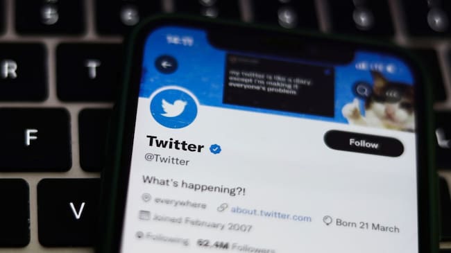Twitter account of Twitter displayed on a phone screen and a laptop keyboard are seen in this illustration photo taken in Krakow, Poland on August 10, 2022. (Photo by Jakub Porzycki/NurPhoto via Getty Images)