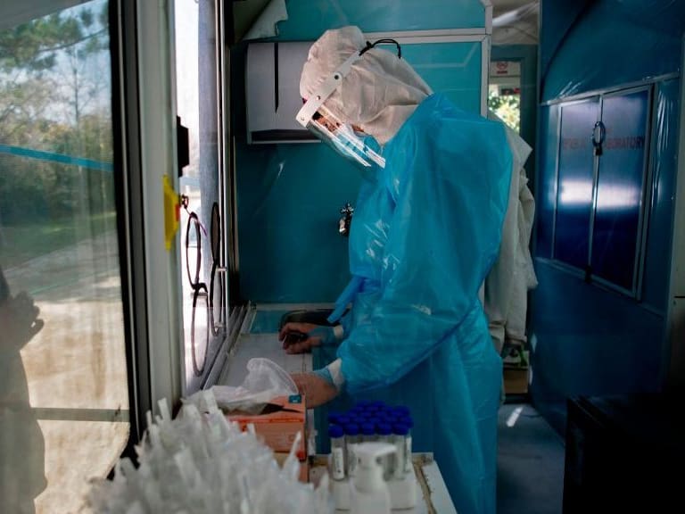 A nurse prepares to carry out a PCR test for the novel coronavirus at the mobile medical center of the municipality of El Bosque, in Santiago on August 25, 2020. - After critical weeks in May and June, Chile managed to keep the new cases of coronavirus stable in most of the country. To avoid upsurges, it is now investing efforts to continue testing massively and to reinforce traceability, the key link to lift quarantines. (Photo by MARTIN BERNETTI / AFP) (Photo by MARTIN BERNETTI/AFP via Getty Images)