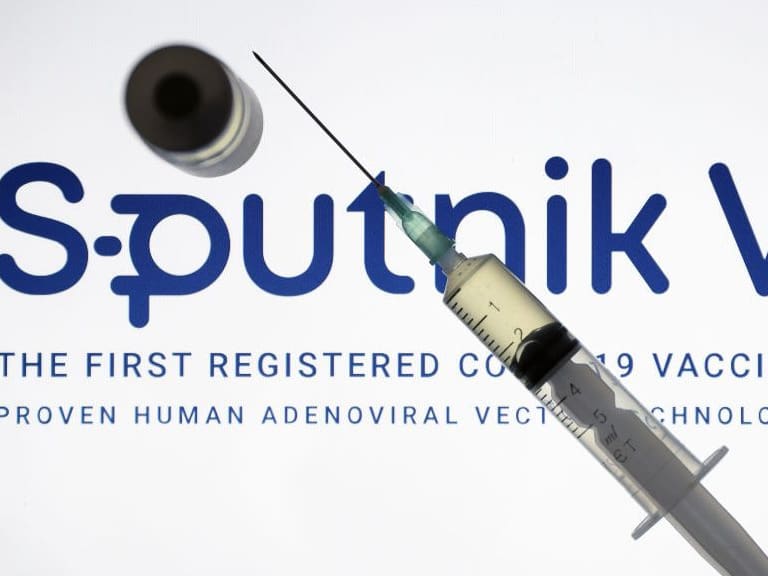 ANKARA, TURKEY - DECEMBER 24: In this photo illustration taken in Ankara, Turkey on December 24, 2020 Sputnik V, (Gam-COVID-Vac), COVID-19 vaccine logo is displayed on a screen with a syringe and a flacon in the front.. (Photo by Hakan Nural/Anadolu Agency via Getty Images)