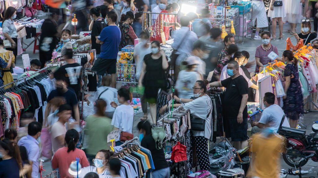 WUHAN, CHINA - JUNE 12, 2020 - In front of Dayang department store, Jianghan Road, Wuhan, a large number of citizens browse in the night market. Wuhan, Hubei Province, China, on the evening of June 12, 2020. Since 0:00 on June 13, the emergency response level of public health emergencies in Hubei Province has been adjusted from level II to level III, and the relevant prevention and control strategies have been adjusted accordingly.- PHOTOGRAPH BY Costfoto / Barcroft Studios / Future Publishing (Photo credit should read Costfoto/Barcroft Media via Getty Images)