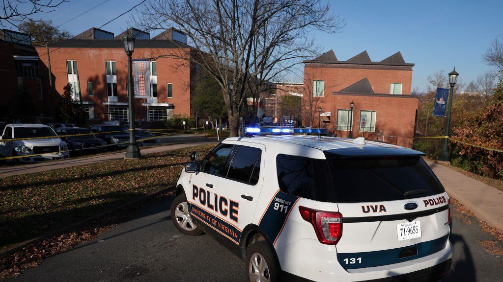 CHARLOTTESVILLE, VIRGINIA - NOVEMBER 14: A law enforcement blocks access to the crime scene where 3 people were killed and 2 others wounded on the grounds of the University of Virginia on November 14, 2022 in Charlottesville, Virginia. The suspect is believed to be a student at the university and is still at large as the campus remains in a shelter in place lockdown. (Photo by Win McNamee/Getty Images)