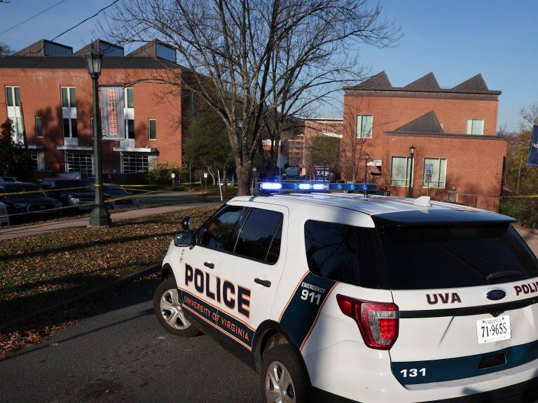 CHARLOTTESVILLE, VIRGINIA - NOVEMBER 14: A law enforcement blocks access to the crime scene where 3 people were killed and 2 others wounded on the grounds of the University of Virginia on November 14, 2022 in Charlottesville, Virginia. The suspect is believed to be a student at the university and is still at large as the campus remains in a shelter in place lockdown. (Photo by Win McNamee/Getty Images)