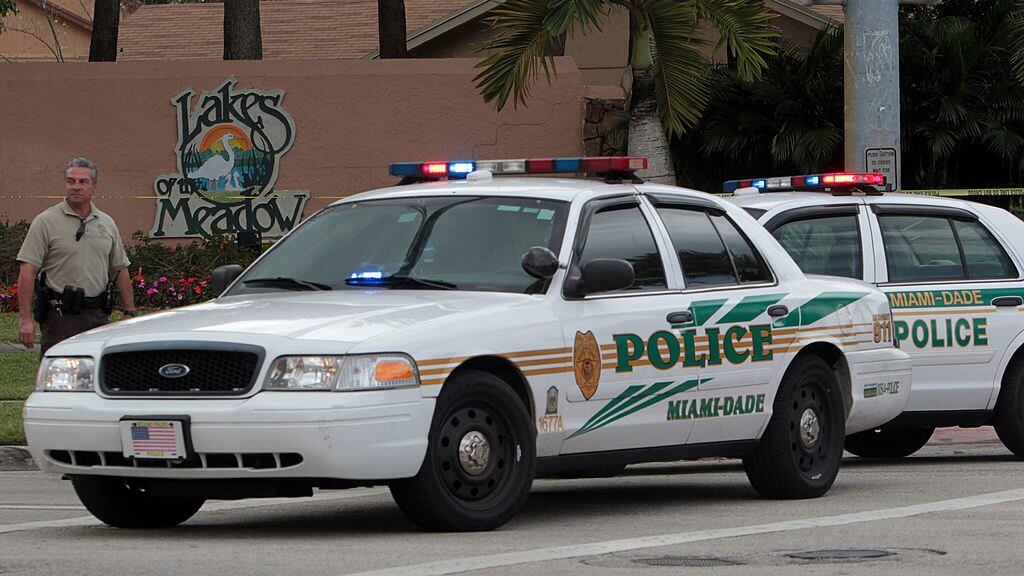 Miami-Dade police investigate a crime scene at the Lakes of the Meadow development in West Kendall, Florida, on Wednesday, February 20, 2013. Suspected marijuana growers engaged police in a shootout, and their home wound up in flames. Police have a suspect in custody and one is believed to have died in a suicide. (Roberto Koltun/El Nuevo Herald/Tribune News Service via Getty Images)